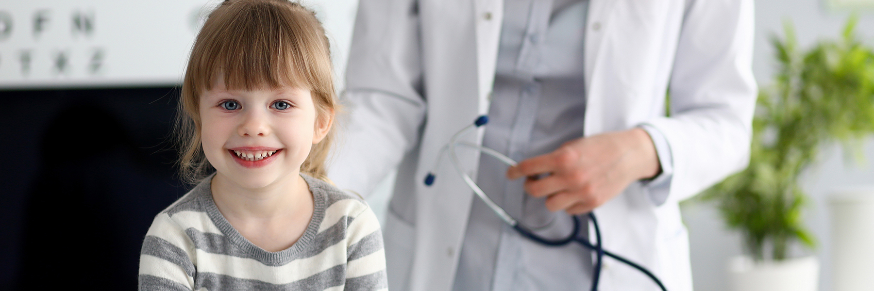 Image of a smiling girl with a doctor.